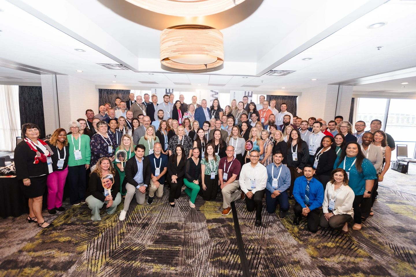 Large group of people at conference gathering.