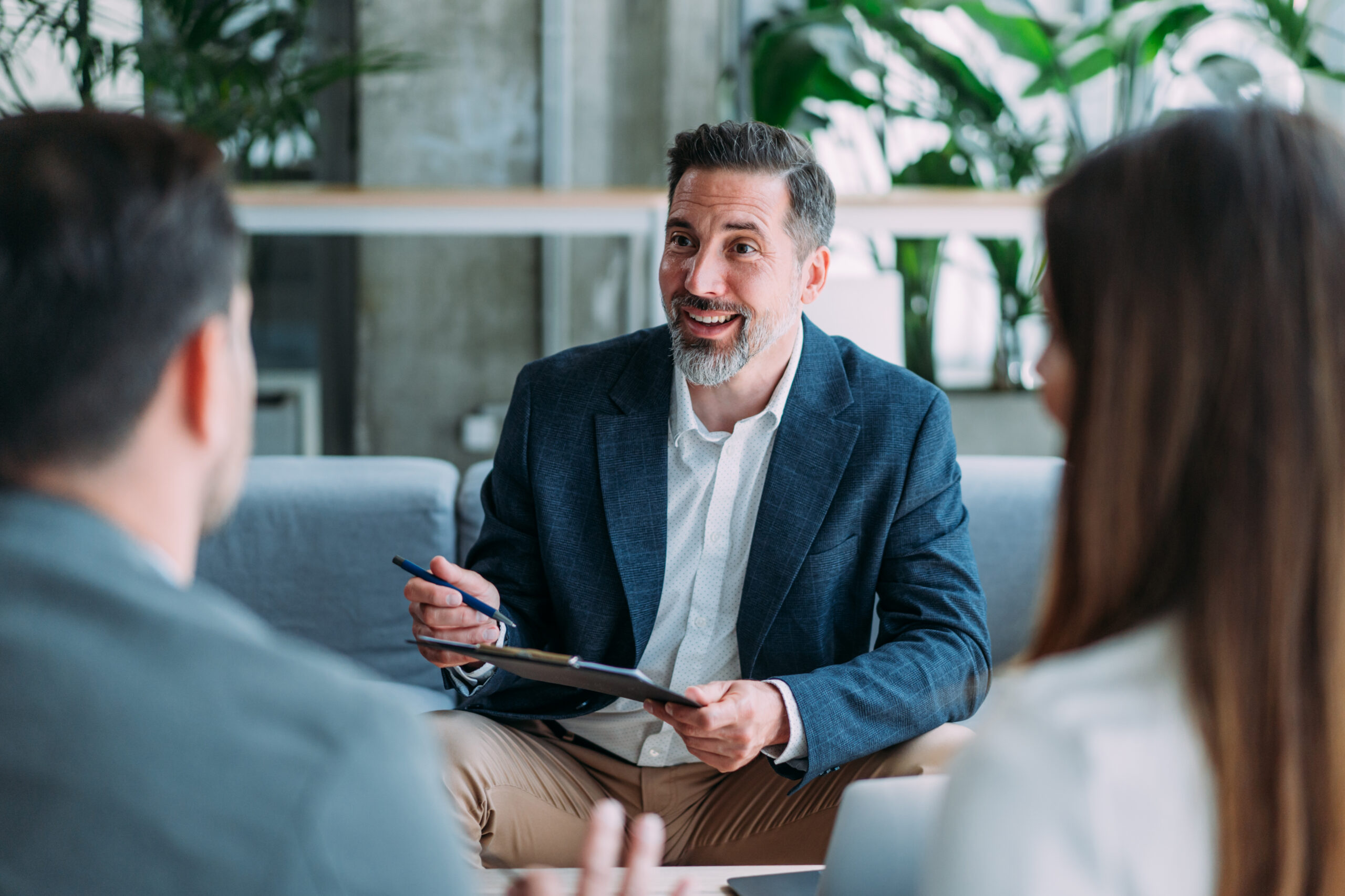 Shot of group of business persons in business meeting. Three entrepreneurs on meeting in board room. Creative business team on meeting in modern office. Male manager discussing new project with his colleagues. Company owner on a meeting with two of his employees in his office.
